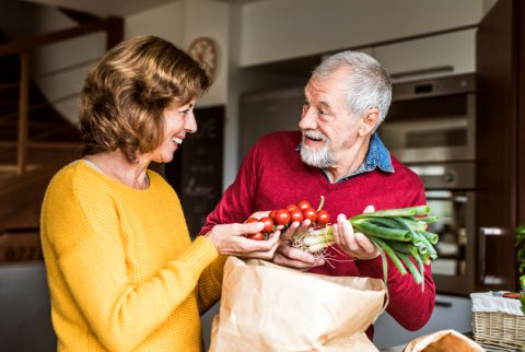 Senior Couple Preparing Food In The Kitchen.