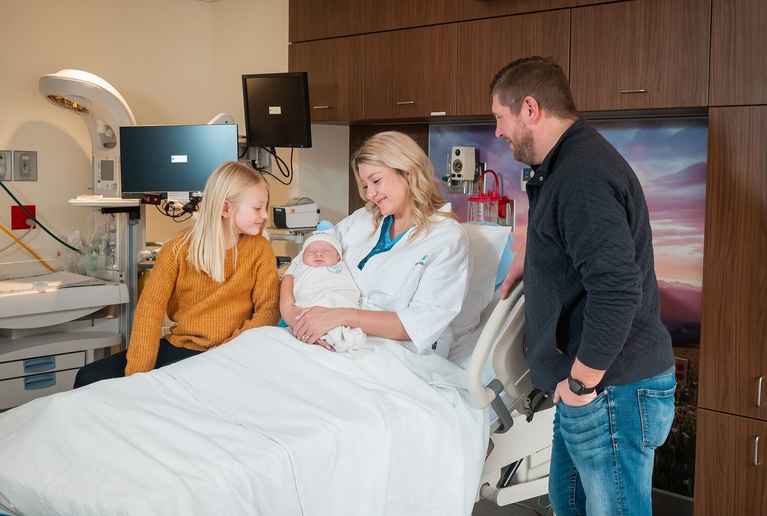 At Vail Health, a family stands beside a hospital bed, captivated by the sight of their precious newborn.