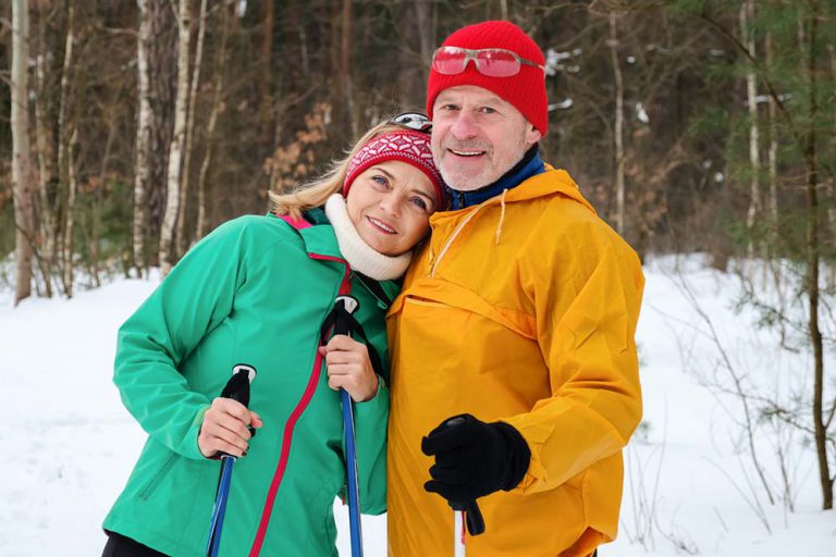Ski couple in the snow - online accounts for charitable giving